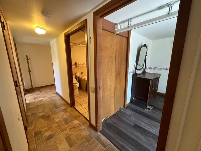 a view of a hallway with wooden walls