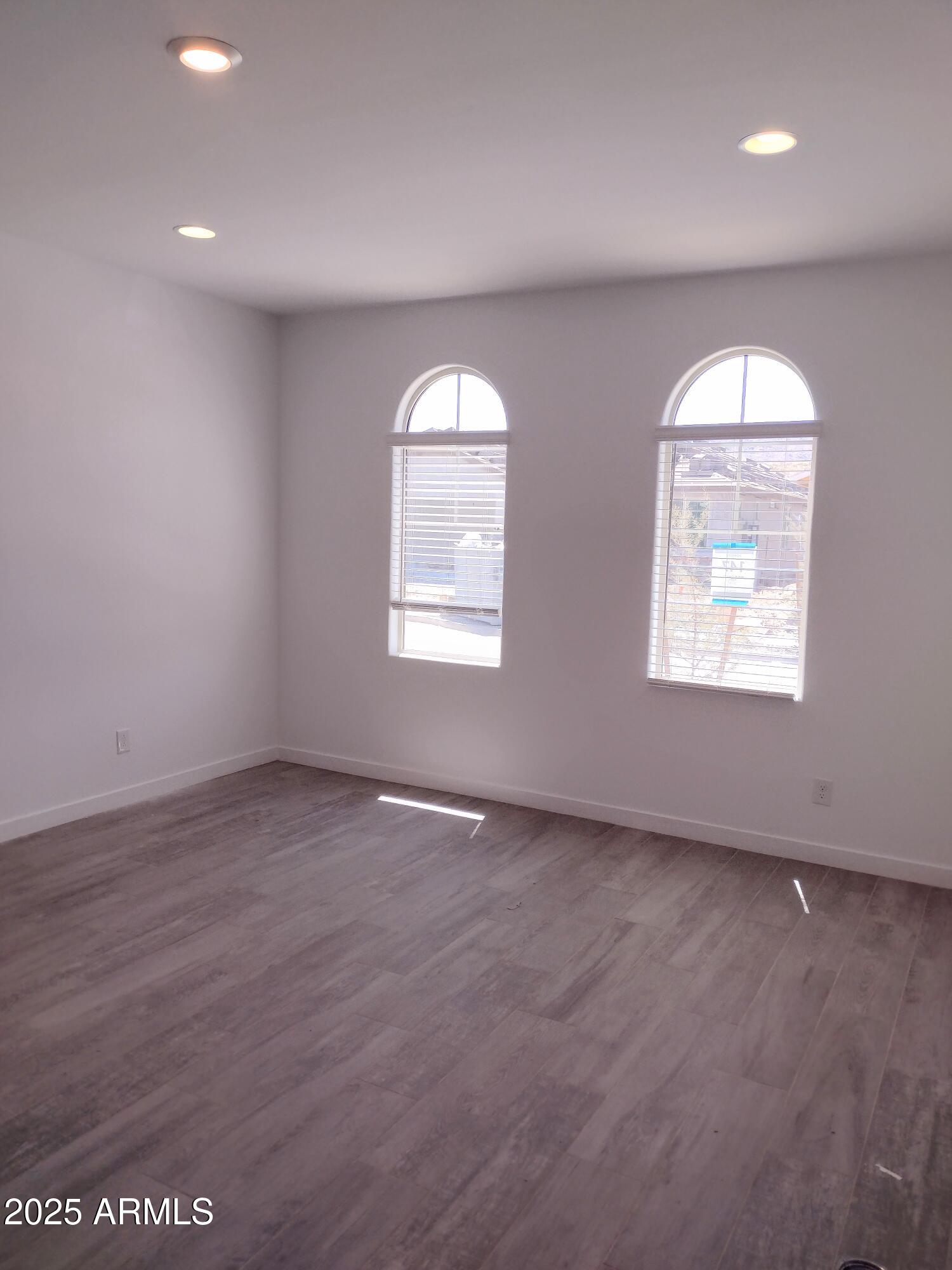 1536 West Corral Road Phoenix, AZ 85041 - Photo 8 of 16 an empty room with windows