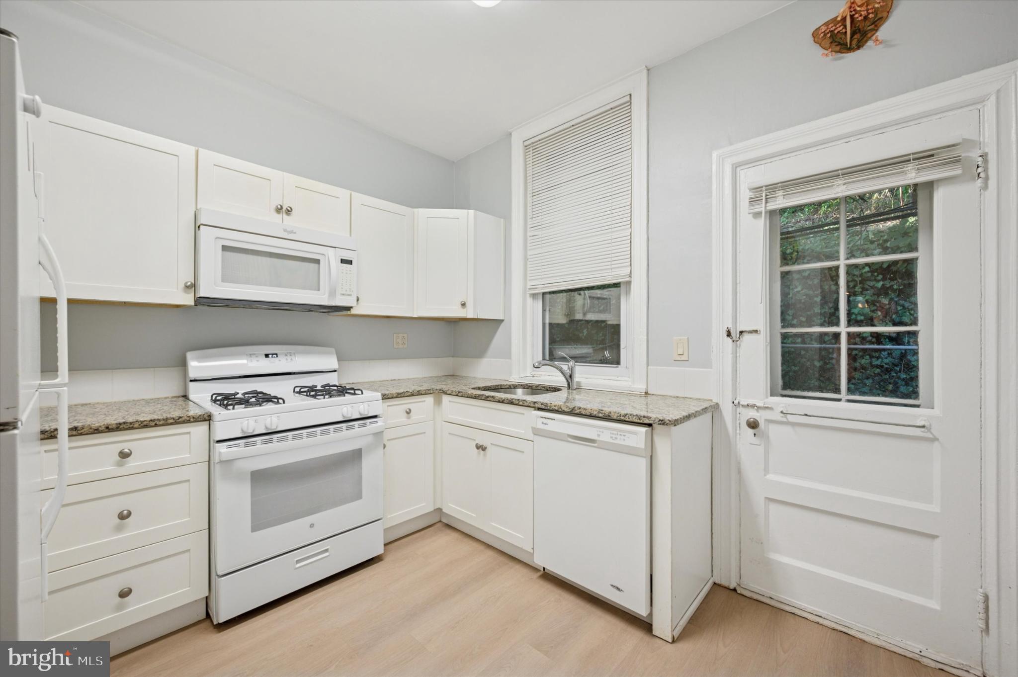 4817 Ridge Avenue Philadelphia, PA 19129 - Photo 23 of 34 a kitchen with granite countertop cabinets appliances and a sink
