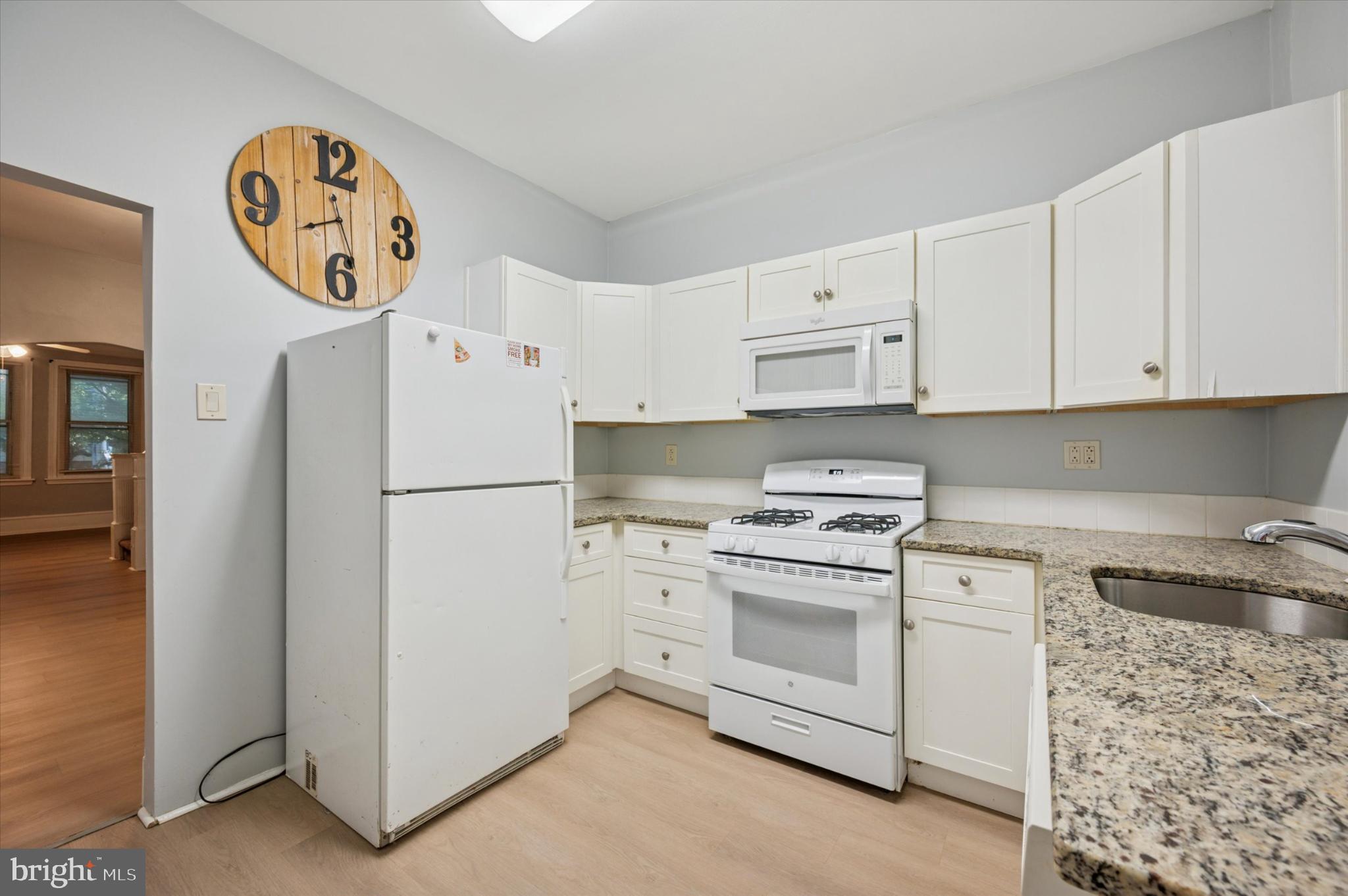 4817 Ridge Avenue Philadelphia, PA 19129 - Photo 24 of 34 a kitchen with white cabinets and white appliances