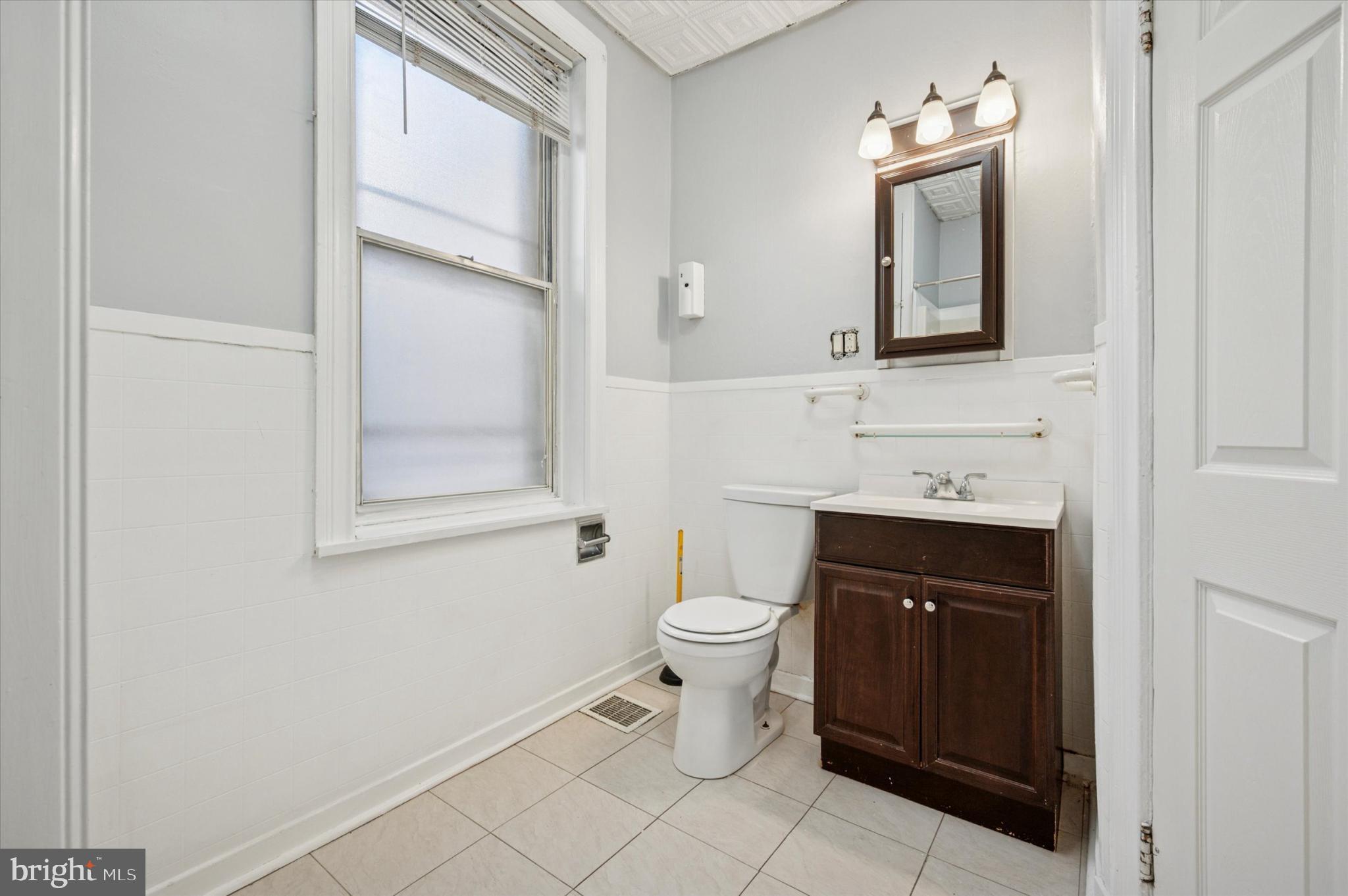 4817 Ridge Avenue Philadelphia, PA 19129 - Photo 29 of 34 a bathroom with a toilet sink and mirror