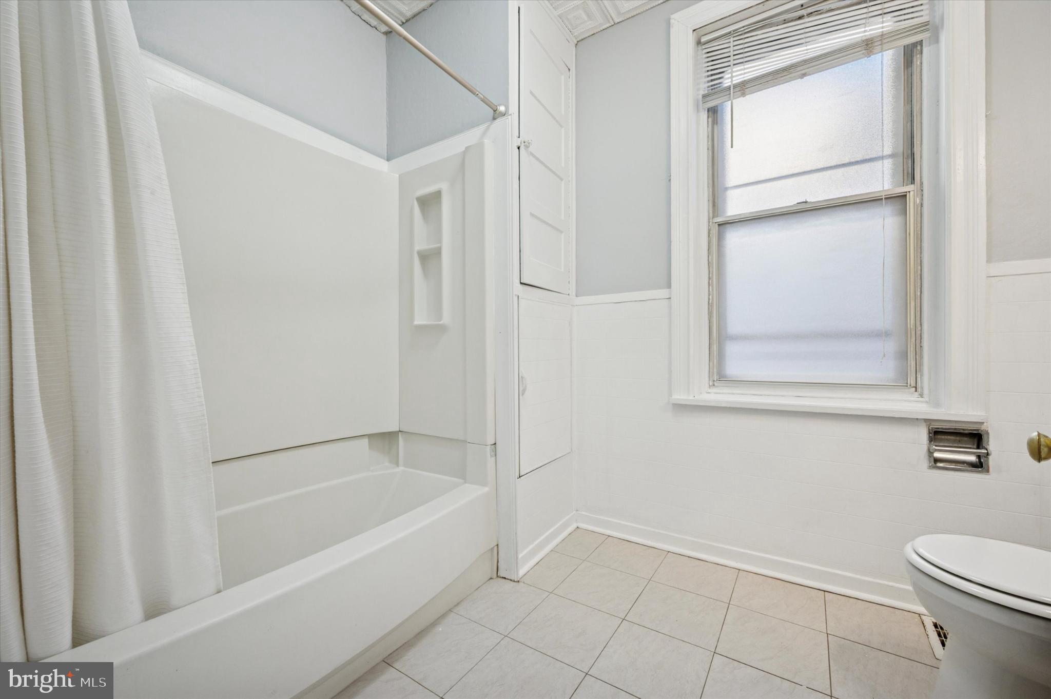 4817 Ridge Avenue Philadelphia, PA 19129 - Photo 30 of 34 a bathroom with a bathtub and a shower