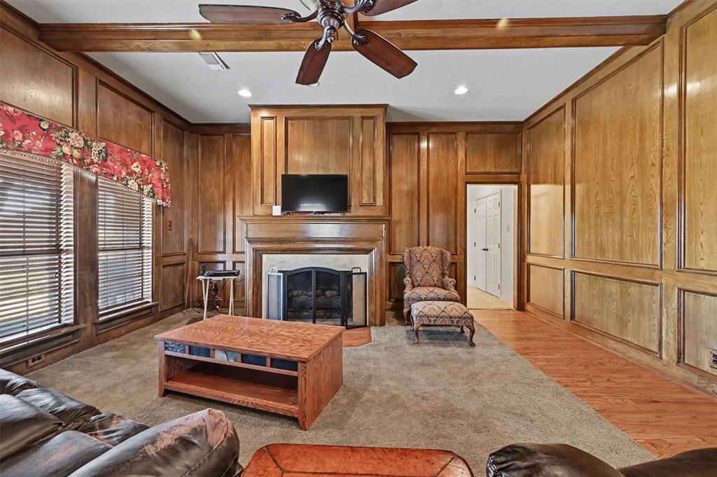 304 Trollinger Street Whitesboro, TX 76273 - Photo 11 of 25 a living room with furniture a flat screen tv and a fireplace