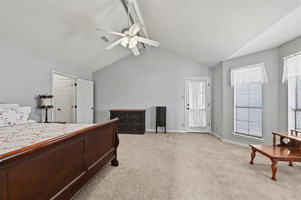 304 Trollinger Street Whitesboro, TX 76273 - Photo 13 of 25 a spacious bedroom with a bed and dresser