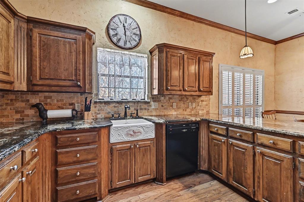 304 Trollinger Street Whitesboro, TX 76273 - Photo 6 of 25 a kitchen with stainless steel appliances granite countertop a sink stove and cabinets