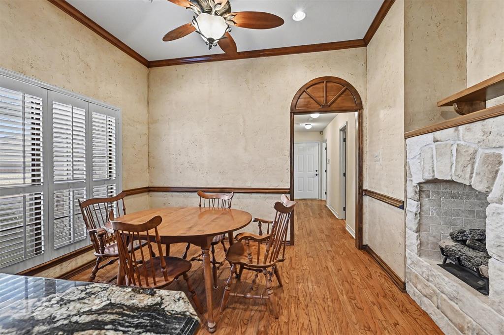 304 Trollinger Street Whitesboro, TX 76273 - Photo 9 of 25 a view of a dining room with furniture and wooden floor