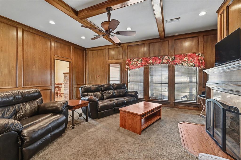 304 Trollinger Street Whitesboro, TX 76273 - Photo 10 of 25 a living room with fireplace furniture and a flat screen tv