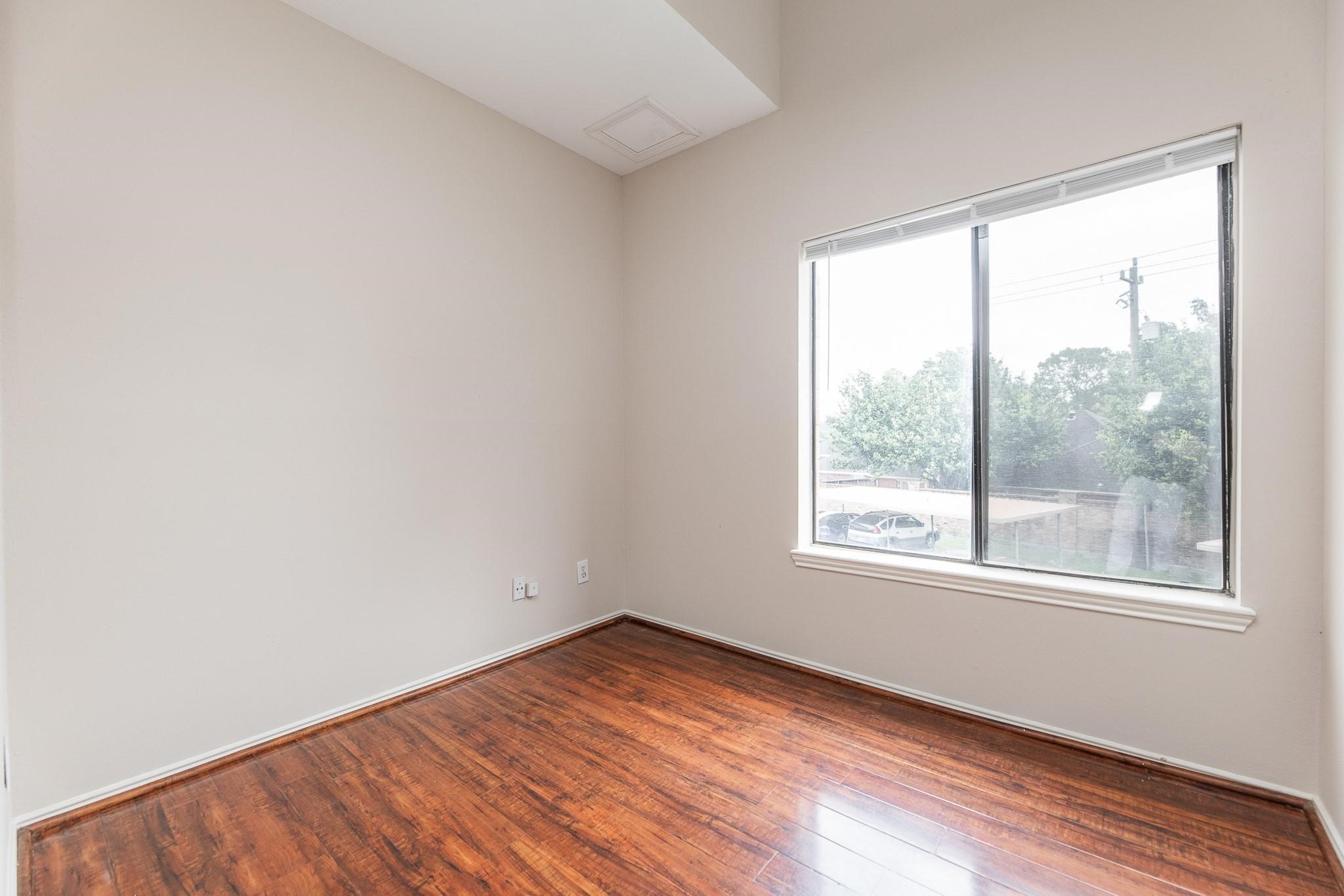 2023 Gentryside Drive, Unit 508 Houston, TX 77077 - Photo 11 of 41 an empty room with wooden floor and windows