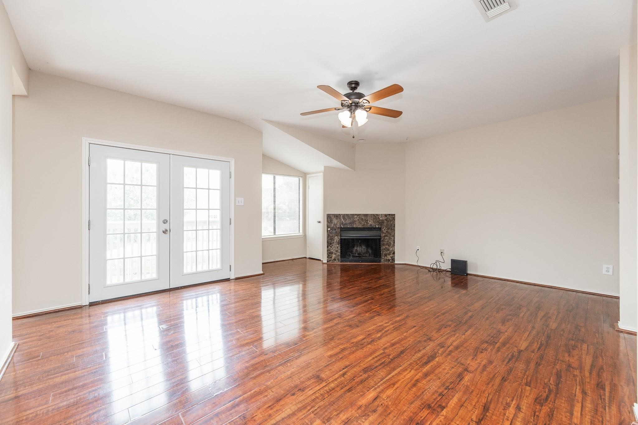 2023 Gentryside Drive, Unit 508 Houston, TX 77077 - Photo 12 of 41 an empty room with wooden floor fireplace and windows