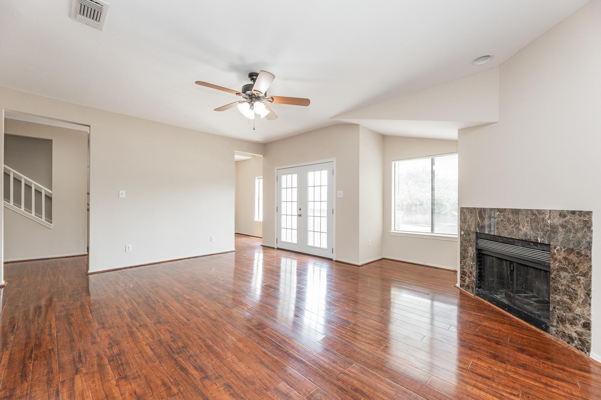 2023 Gentryside Drive, Unit 508 Houston, TX 77077 - Photo 13 of 41 a view of an empty room with wooden floor and a fireplace