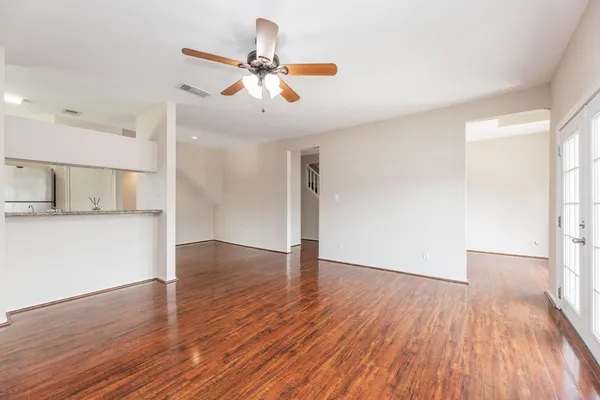 a view of an empty room with a fireplace and a window