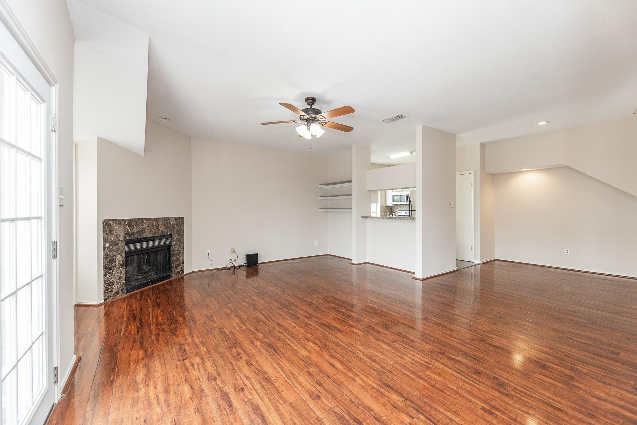 2023 Gentryside Drive, Unit 508 Houston, TX 77077 - Photo 15 of 41 a view of an empty room with a fireplace and a window
