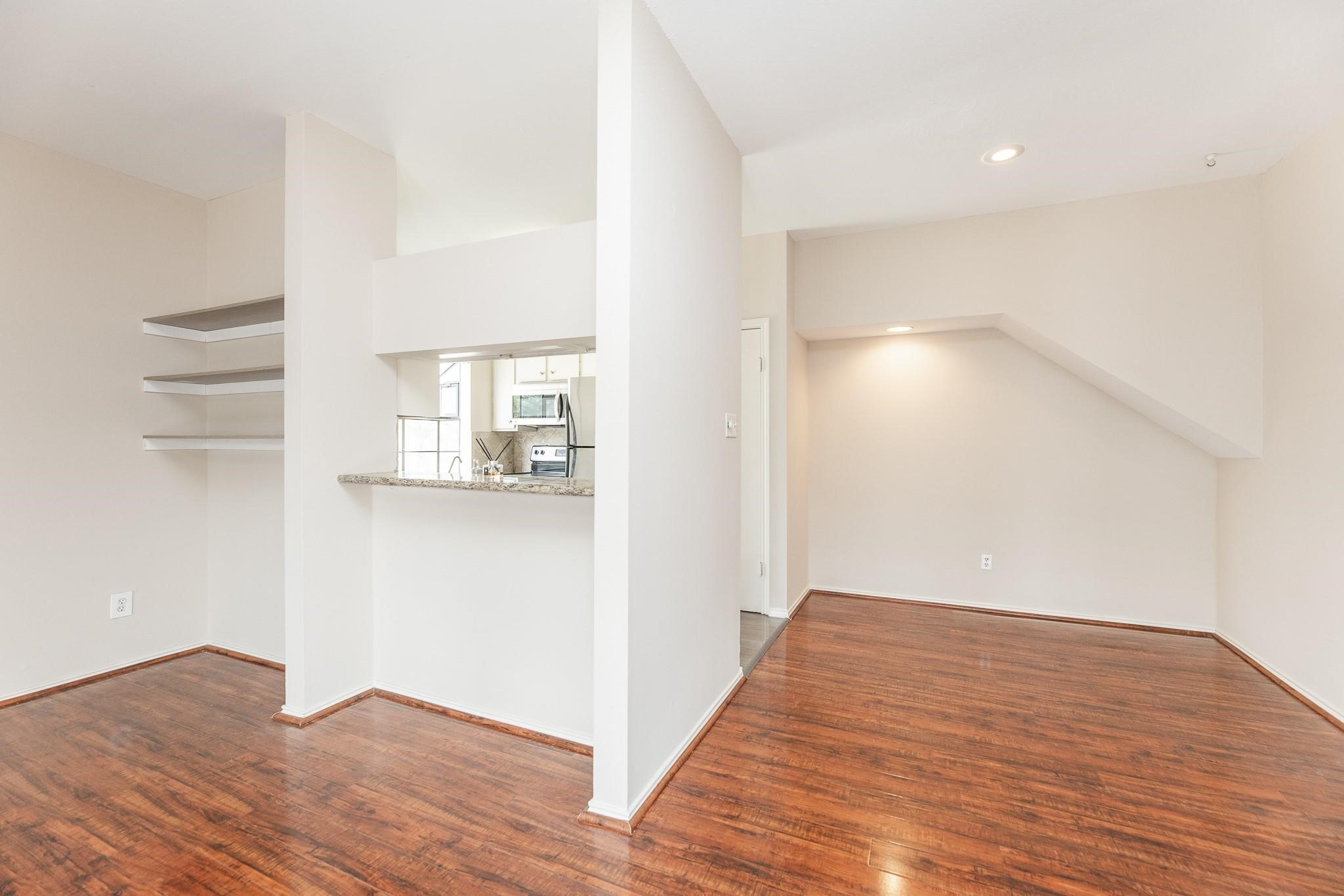 2023 Gentryside Drive, Unit 508 Houston, TX 77077 - Photo 18 of 41 a view of empty room with wooden floor and kitchen