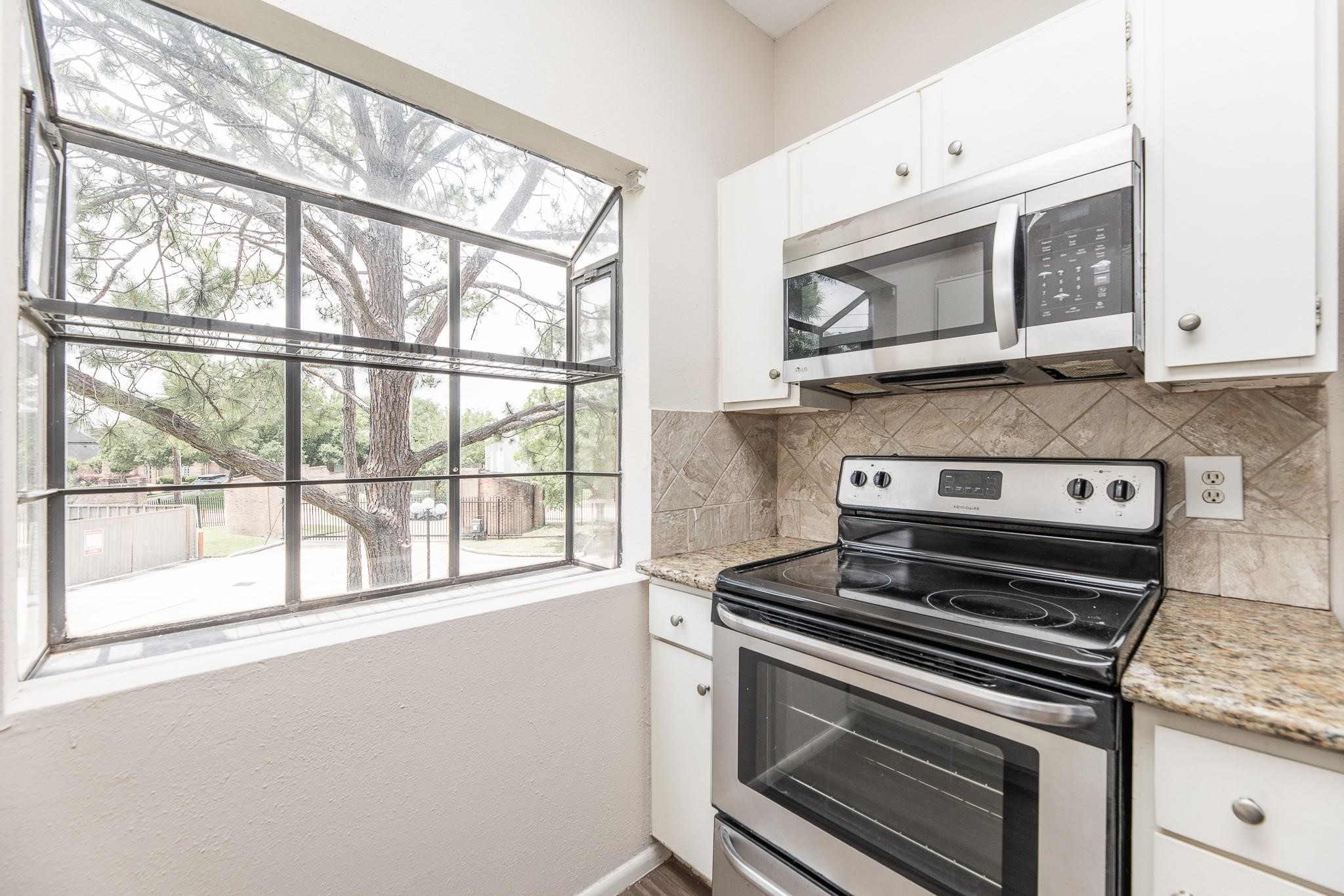 2023 Gentryside Drive, Unit 508 Houston, TX 77077 - Photo 22 of 41 a kitchen with a stove and a microwave
