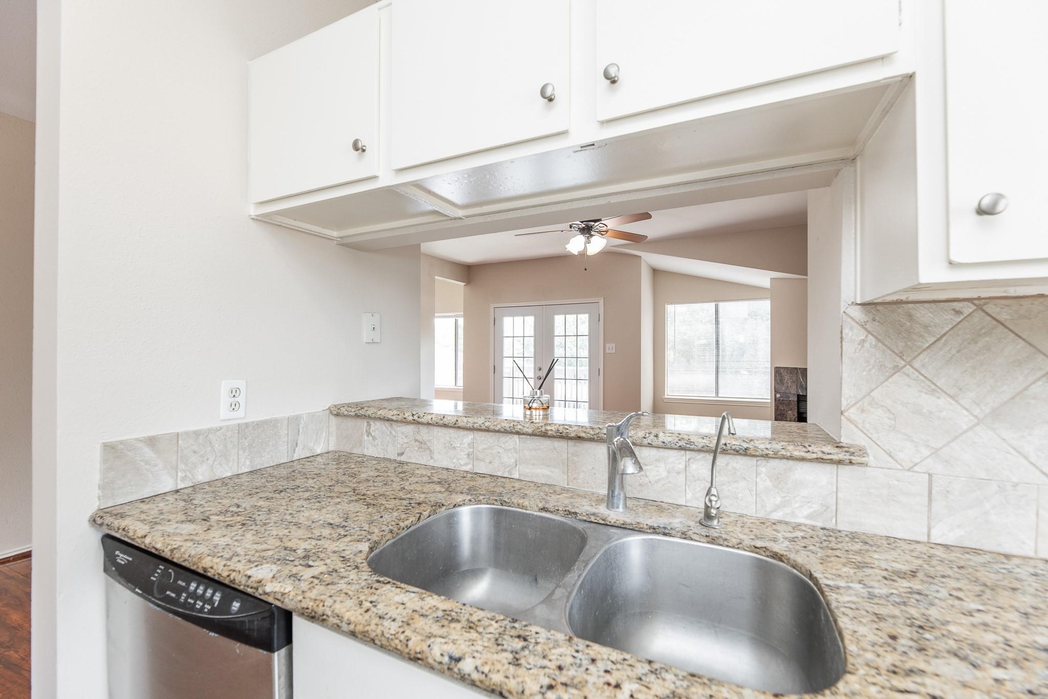 2023 Gentryside Drive, Unit 508 Houston, TX 77077 - Photo 23 of 41 a kitchen with a granite countertop sink and cabinets