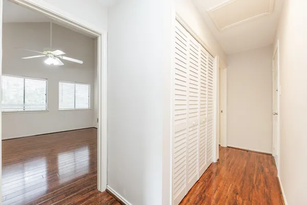 a view of empty room with wooden floor