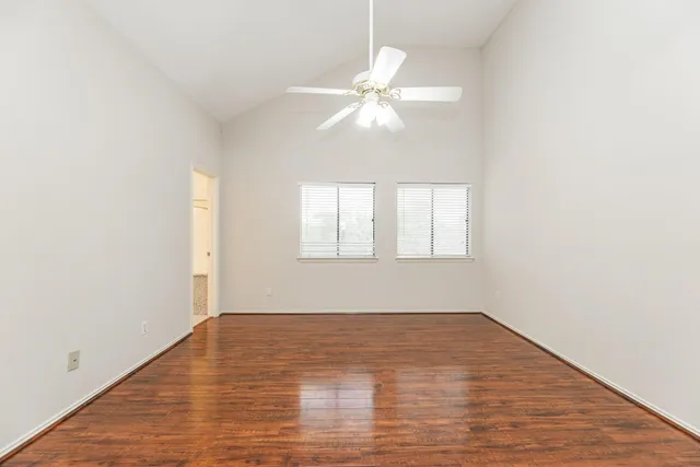 wooden floor in an empty room with a window