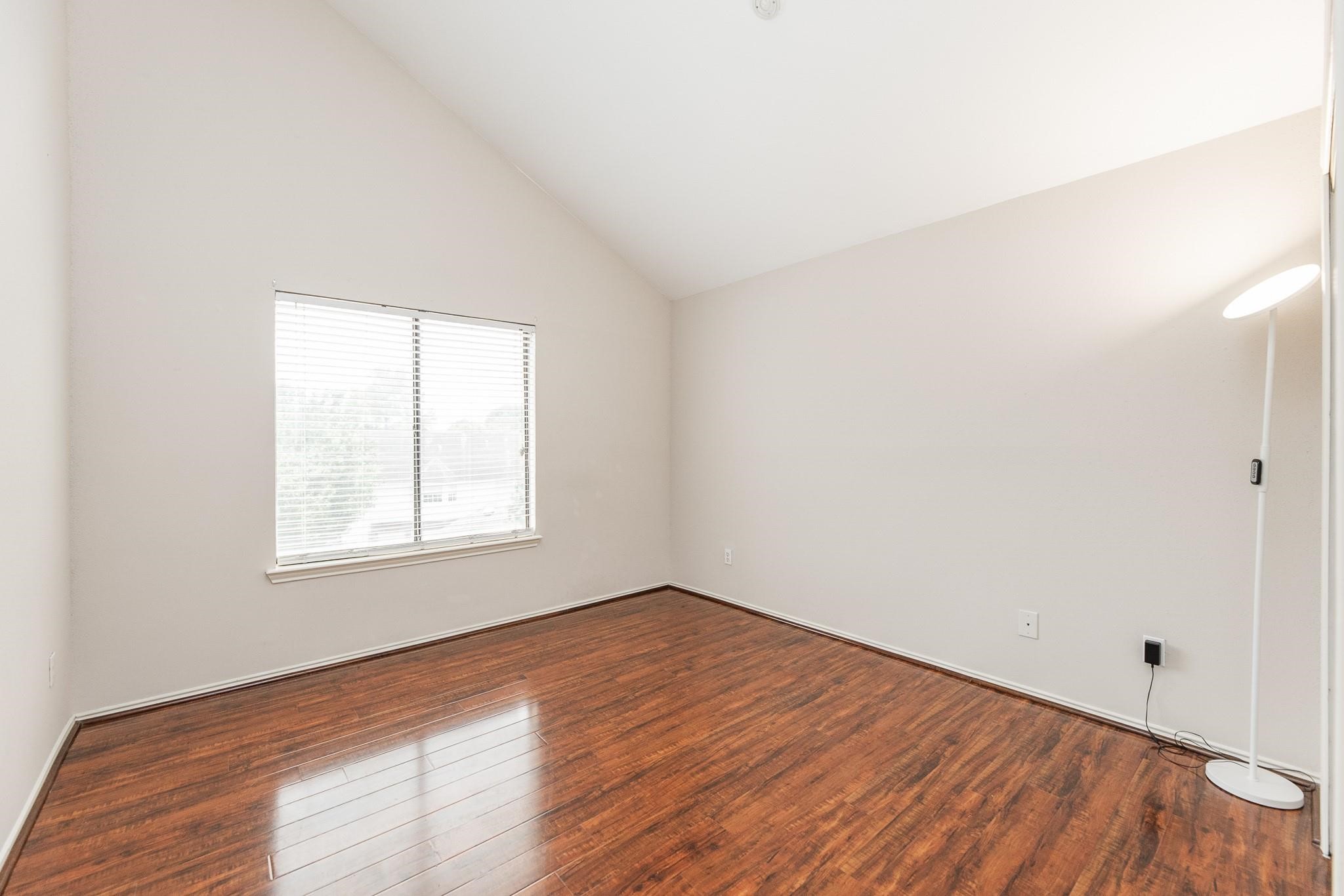 2023 Gentryside Drive, Unit 508 Houston, TX 77077 - Photo 33 of 41 an empty room with wooden floor and windows
