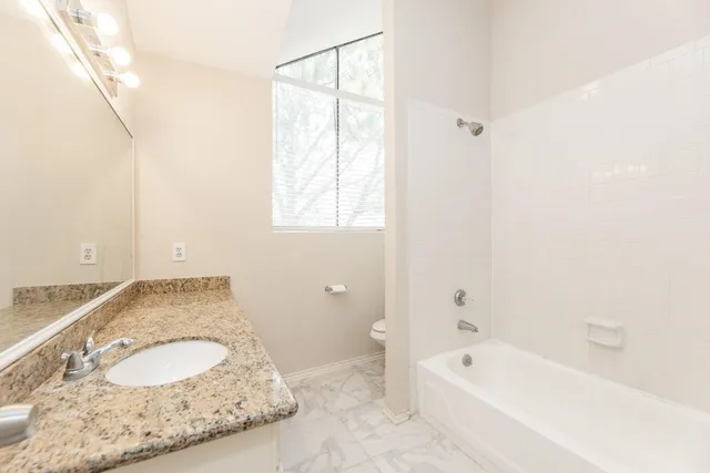 a bathroom with a shower and a window