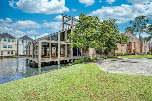 a view of a house with swimming pool and porch with furniture