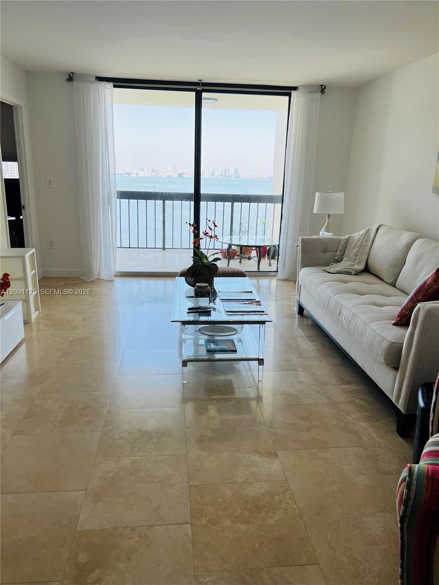 2333 Brickell Avenue, Unit 1803 Miami, FL 33129 - Photo 15 of 23 a living room with furniture and a large window