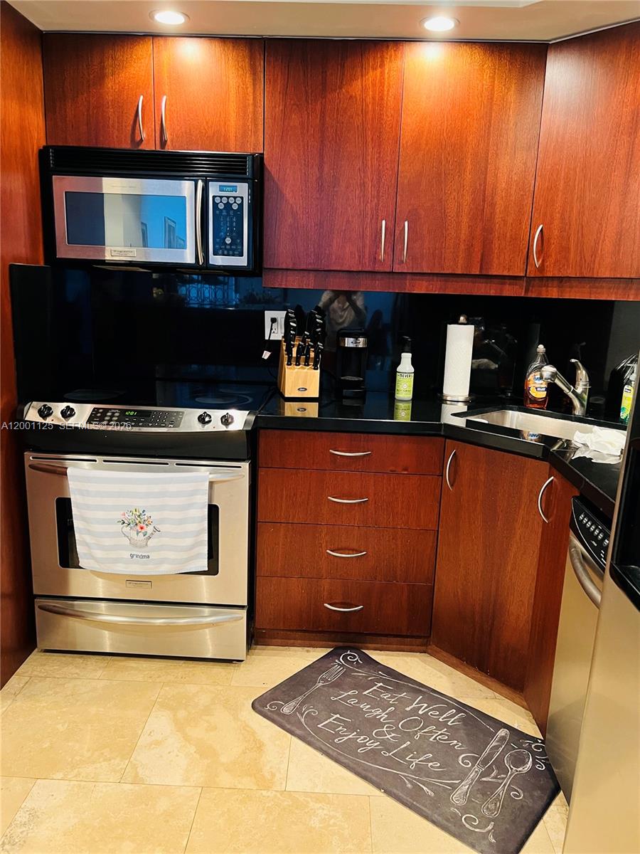2333 Brickell Avenue, Unit 1803 Miami, FL 33129 - Photo 20 of 23 a stove top oven sitting inside of a kitchen