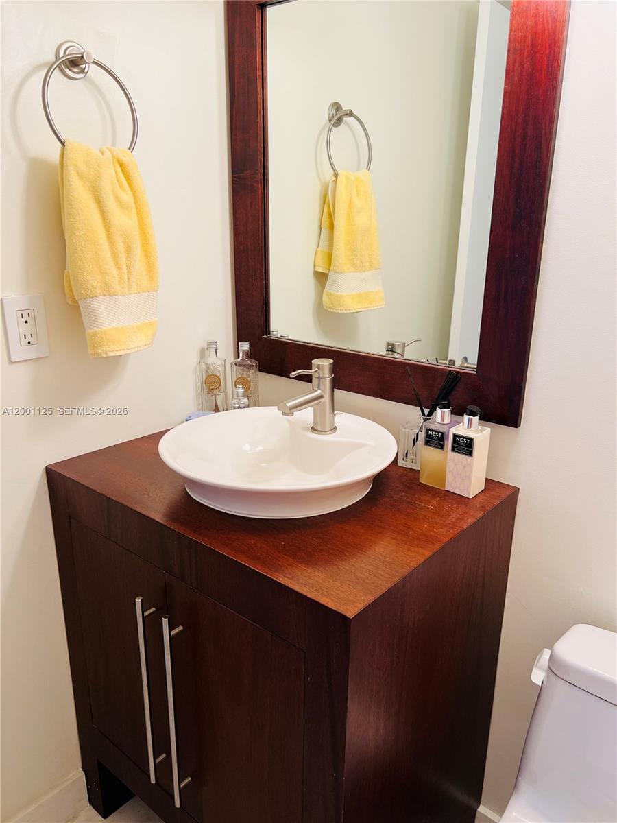 2333 Brickell Avenue, Unit 1803 Miami, FL 33129 - Photo 22 of 23 a bathroom with a sink a mirror and a toilet