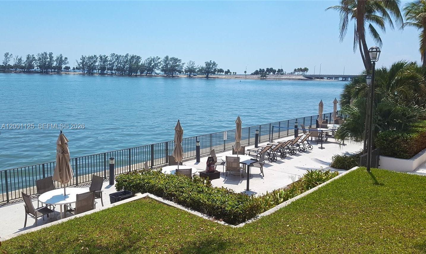 2333 Brickell Avenue, Unit 1803 Miami, FL 33129 - Photo 9 of 23 a view of a lake with couches and wooden fence