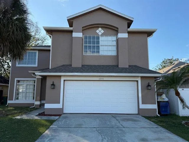 a view of a livingroom with wooden floor and a ceiling fan