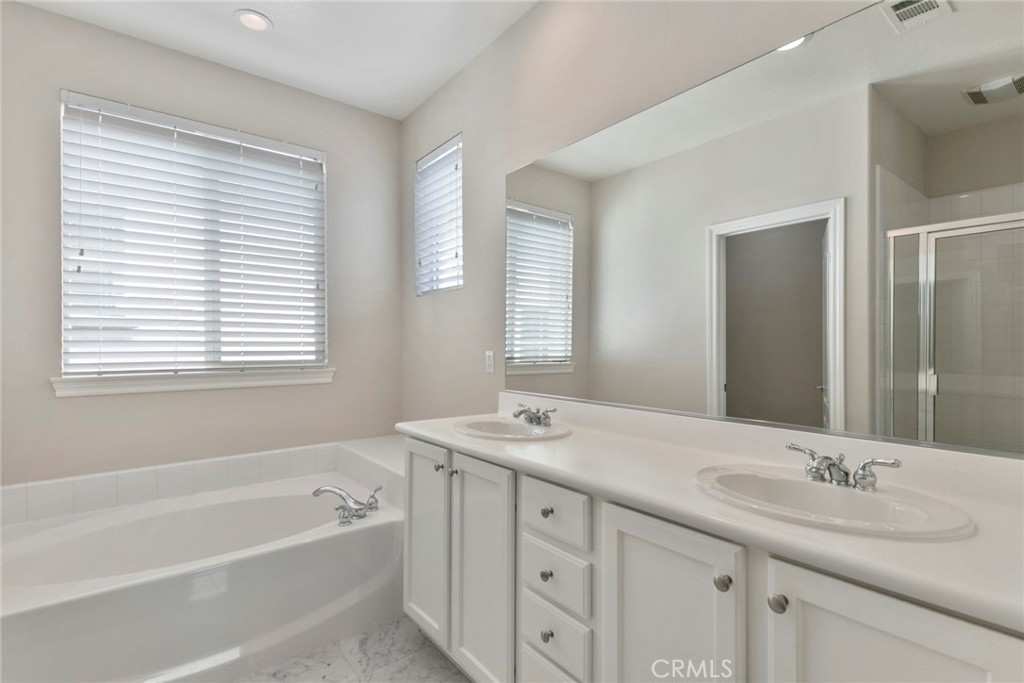 63 Figtree Irvine, CA 92603 - Photo 11 of 14 a bathroom with a granite countertop sink tub double vanity and mirror