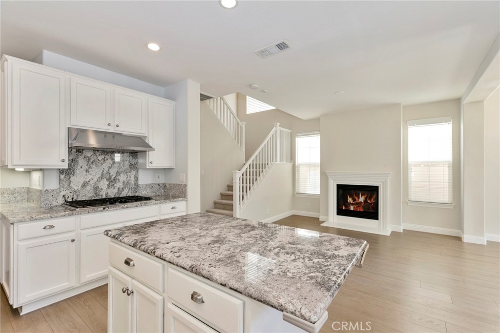 63 Figtree Irvine, CA 92603 - Photo 3 of 14 a kitchen with white cabinets and sink