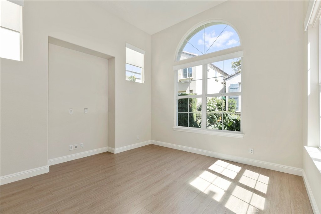 63 Figtree Irvine, CA 92603 - Photo 5 of 14 an empty room with wooden floor and windows