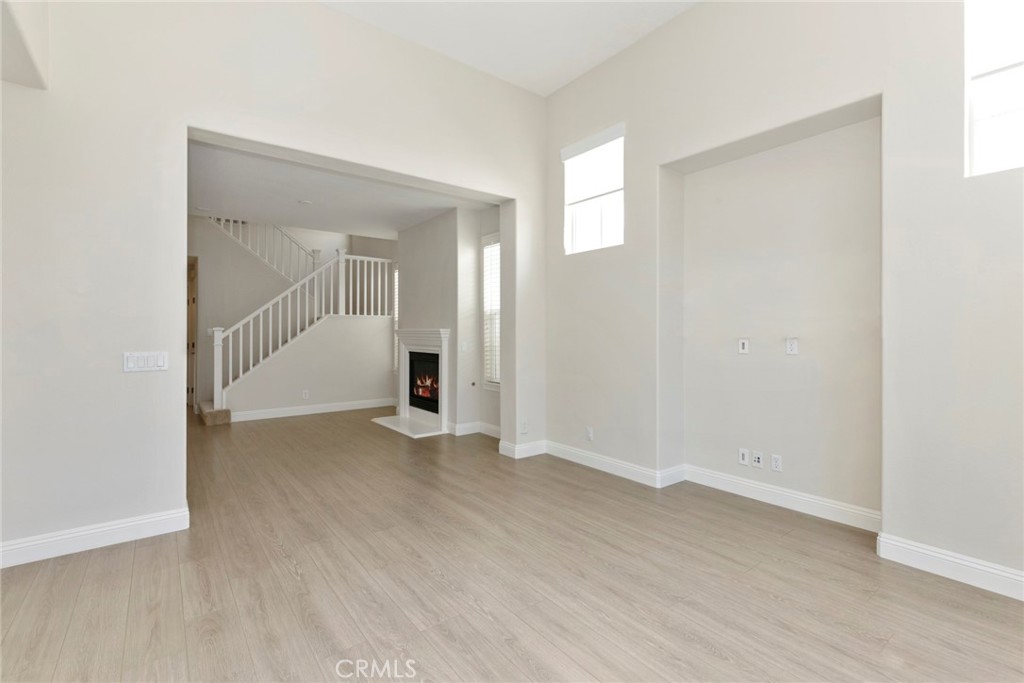 63 Figtree Irvine, CA 92603 - Photo 6 of 14 an empty room with wooden floor and mirror