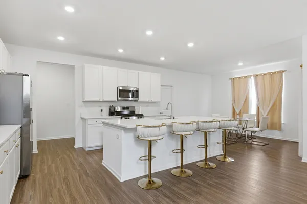 a kitchen with a sink cabinets and wooden floor