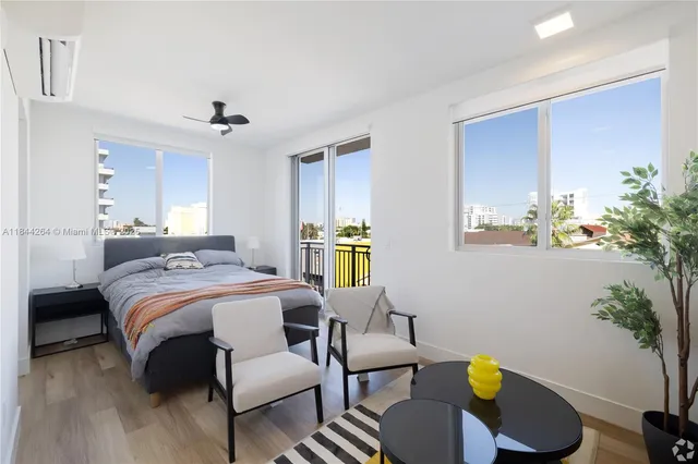a bedroom with furniture and a potted plant