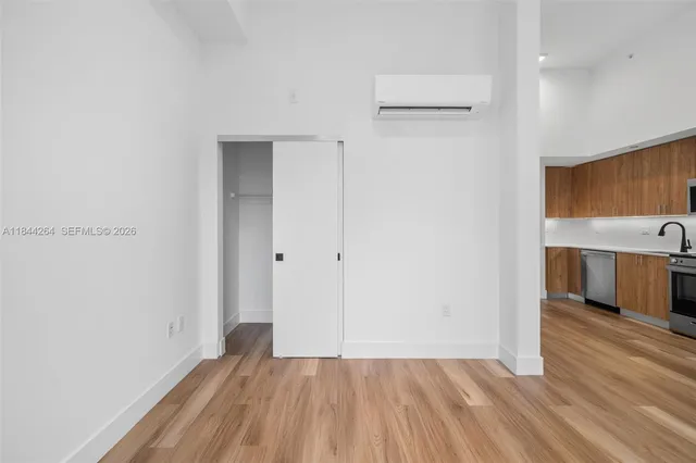 a view of a room with wooden floor