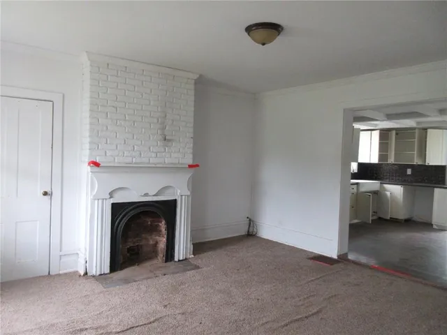 a view of a livingroom with a fireplace and cabinet