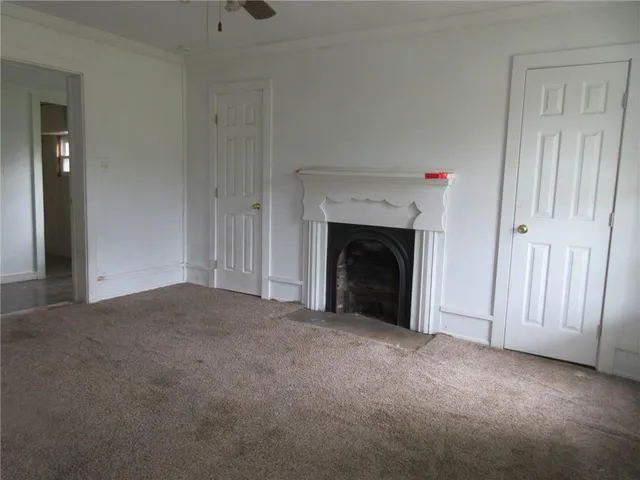 a view of empty room with a fireplace