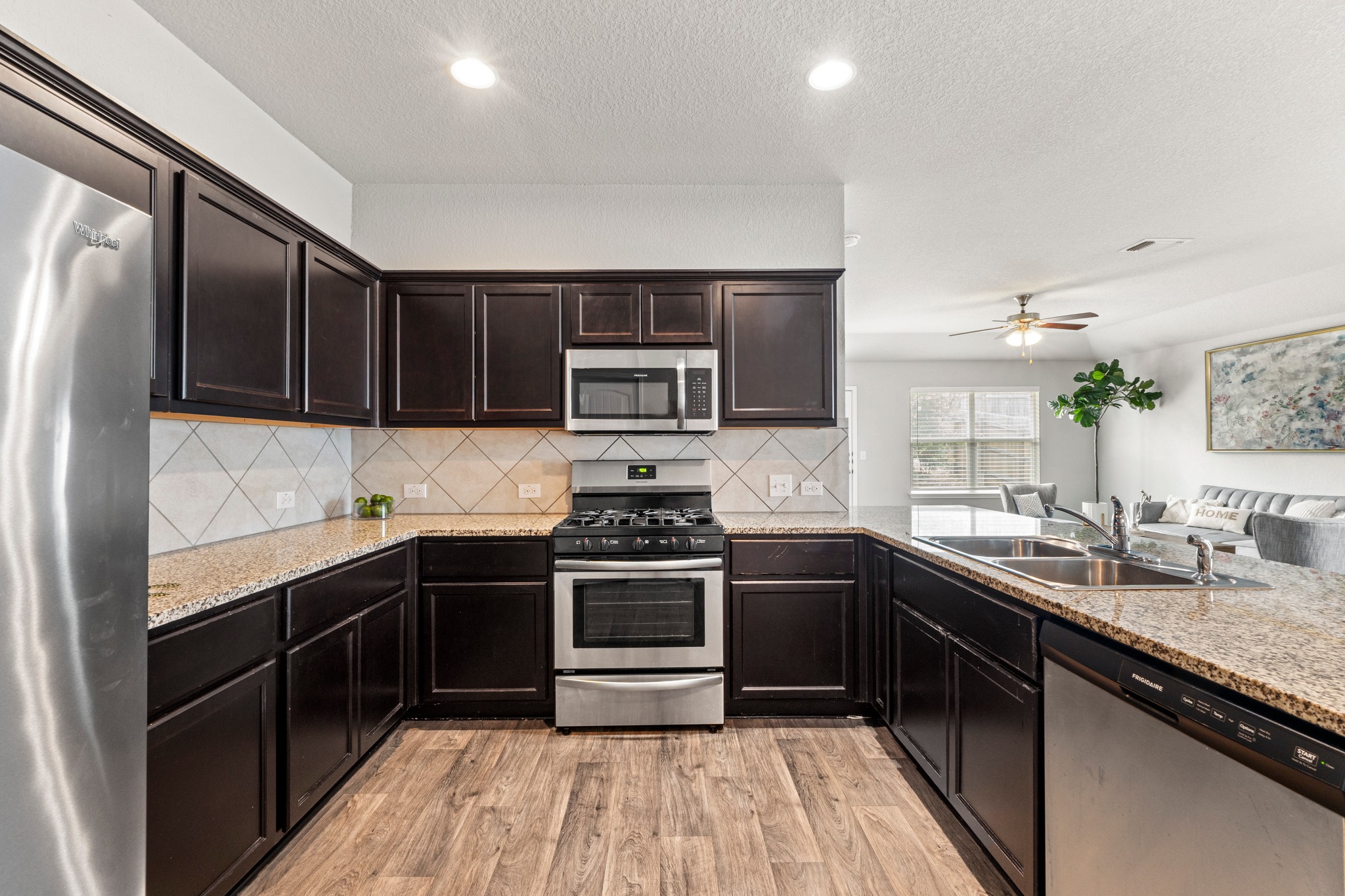 10809 Gonzales Ranger Pass Austin, TX 78754 - Photo 15 of 37 Stainless steel appliances include a gas range, microwave, and dishwasher.