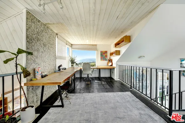 a spacious bathroom with a table chairs and a sink