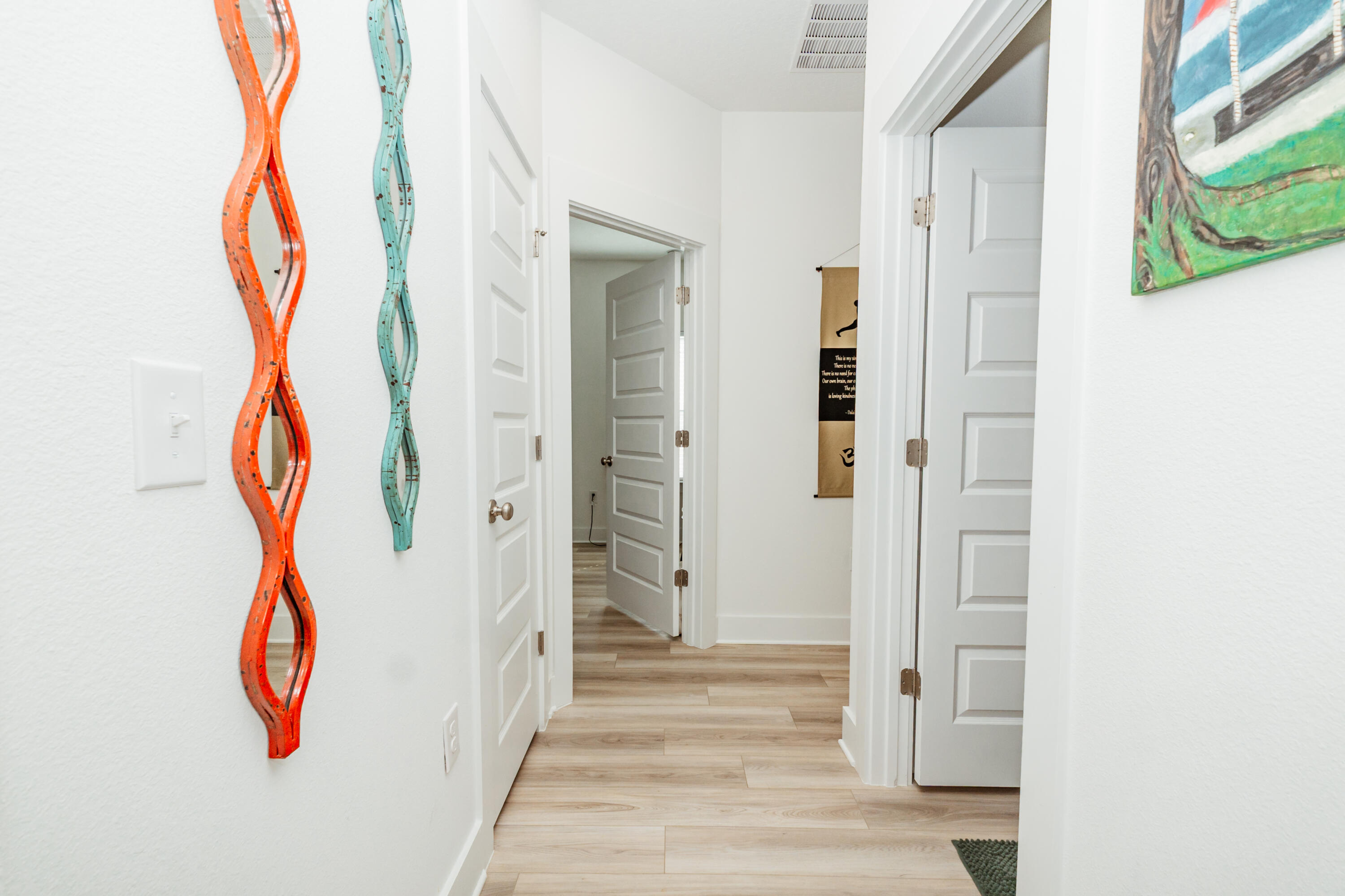 231 Lyla Lane Crestview, FL 32539 - Photo 14 of 27 a view of a hallway with wooden floor and entryway