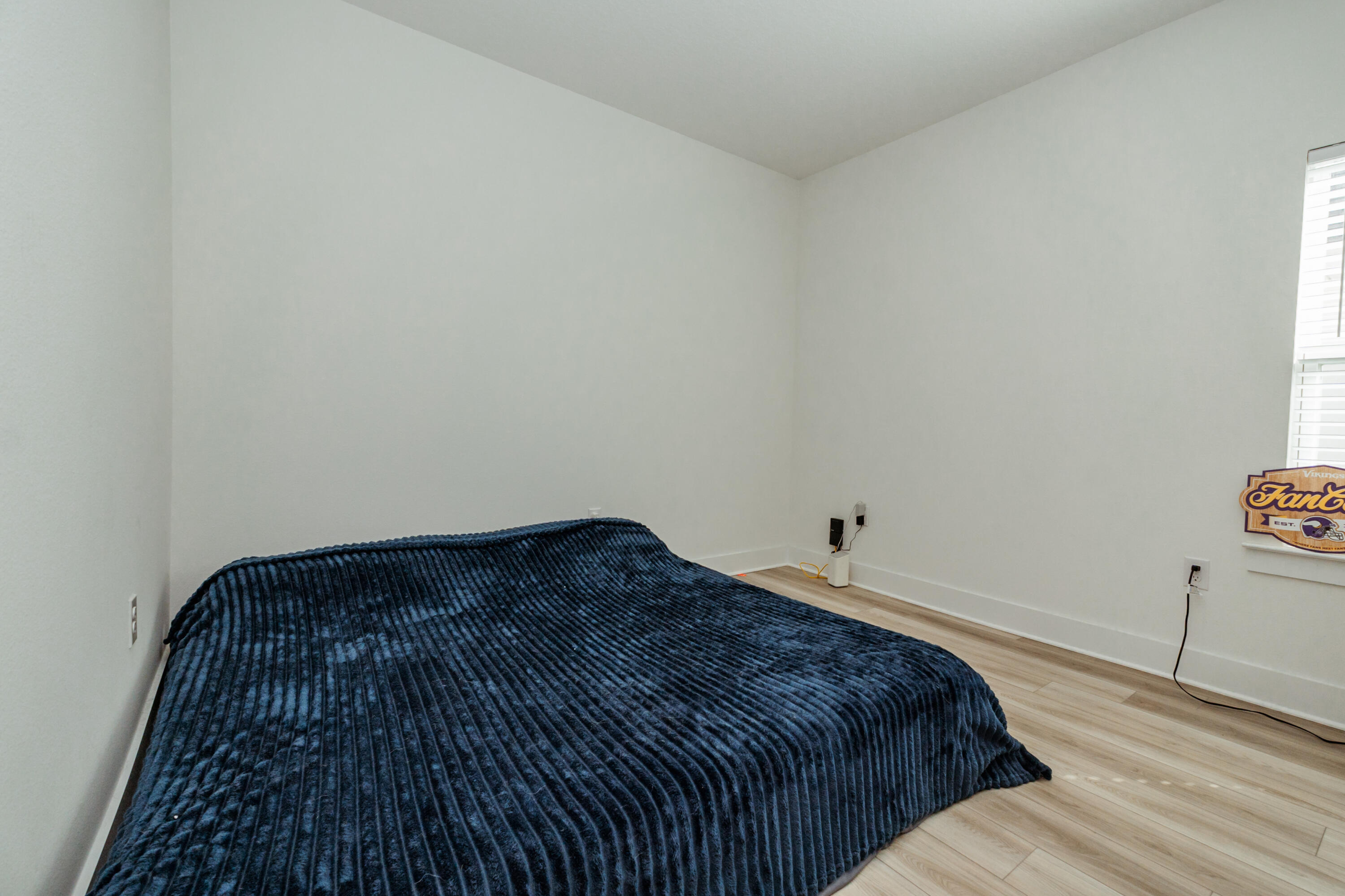 231 Lyla Lane Crestview, FL 32539 - Photo 16 of 27 a bedroom with a bed and wooden floor