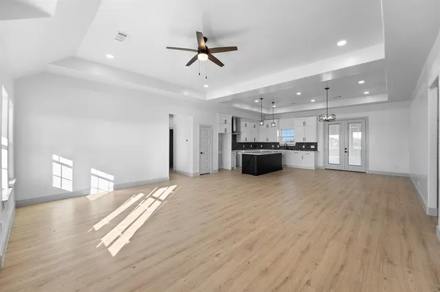 a large kitchen with kitchen island a sink stainless steel appliances and cabinets