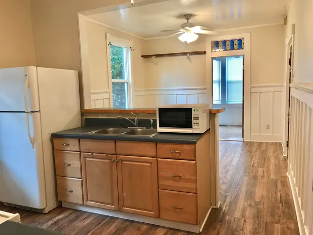 a kitchen with stainless steel appliances granite countertop a stove a sink and a microwave