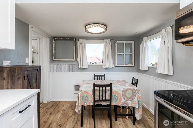 a kitchen with a table chairs a sink and cabinets