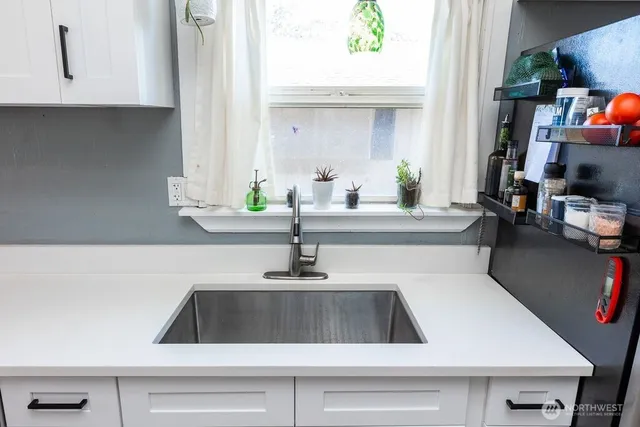 a kitchen with a sink and a potted plant