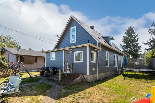 a view of a house with backyard tub and sitting area