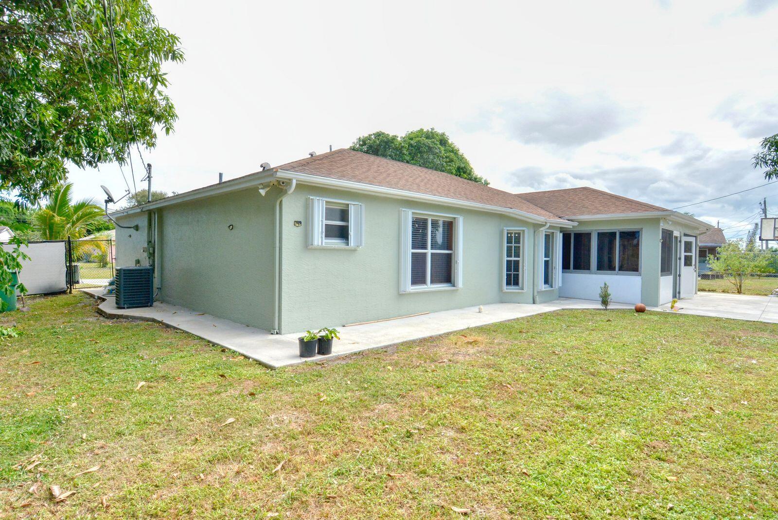 220 West Arbor Avenue Port St. Lucie, FL 34952 - Photo 29 of 32 a view of a house with backyard and garden