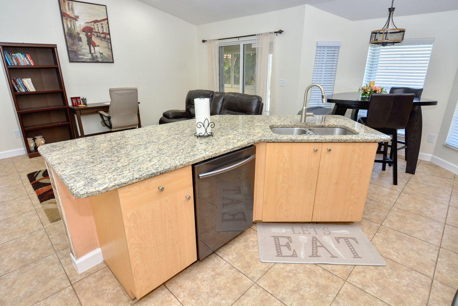 220 West Arbor Avenue Port St. Lucie, FL 34952 - Photo 9 of 32 a kitchen with stainless steel appliances granite countertop a sink stove and refrigerator