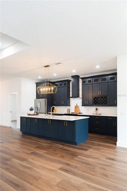 15364 Newport Road Clearwater, FL 33764 - Photo 18 of 50 a view of kitchen and kitchen island with wooden floors